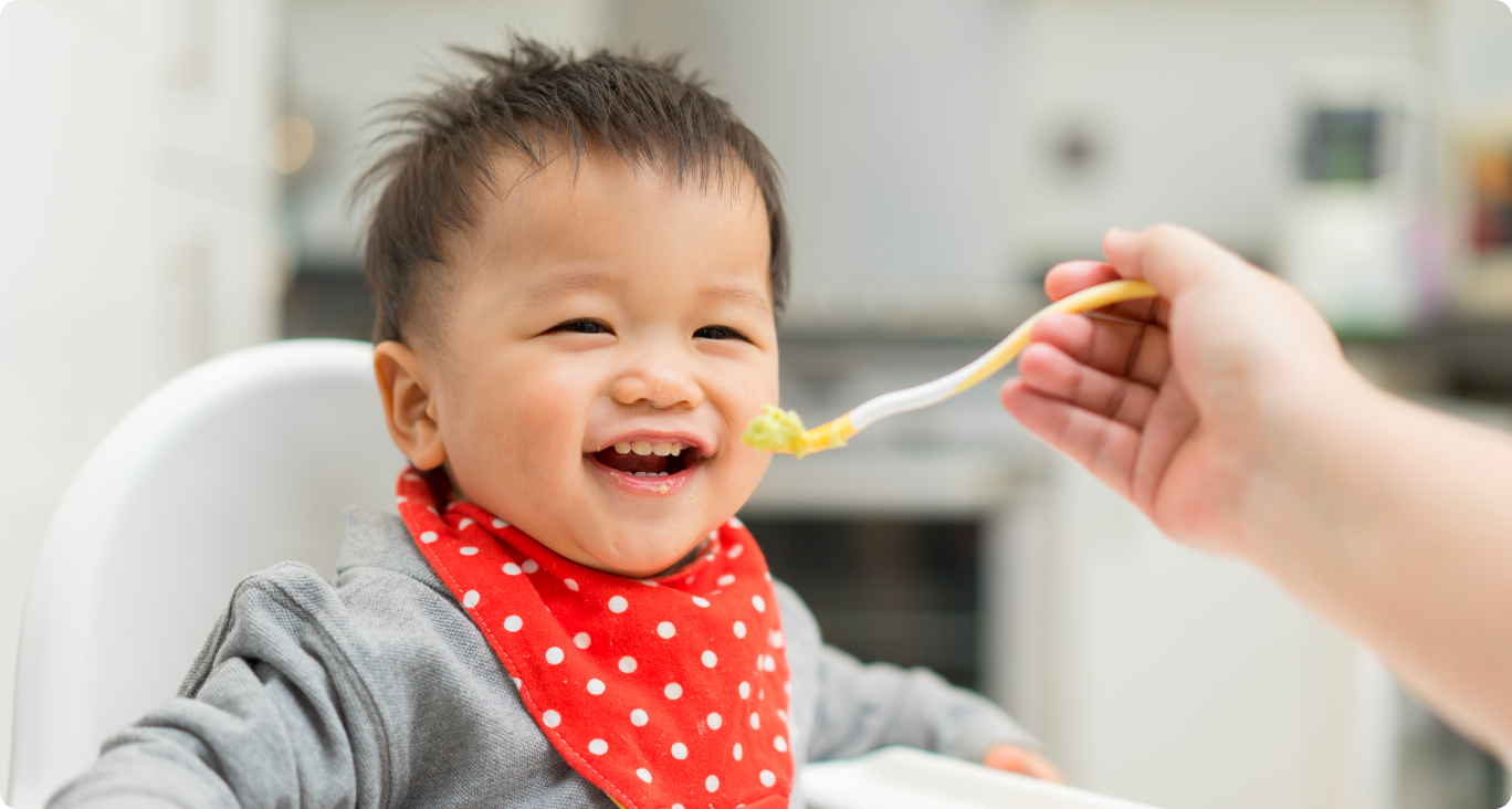 Baby eating happy from spoon