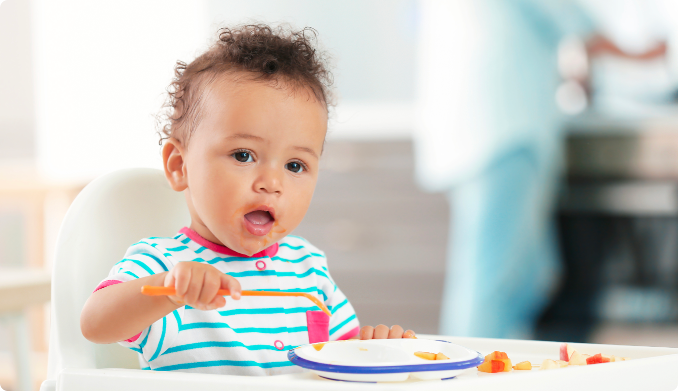 Baby eating fruit