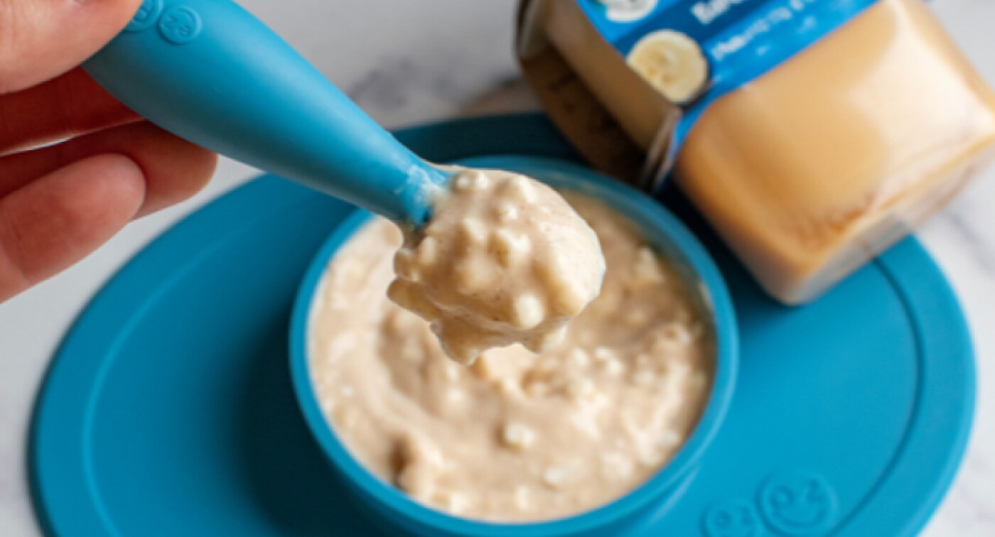 Bowl and spoonful of cottage cheese mixed with Gerber banana puree.