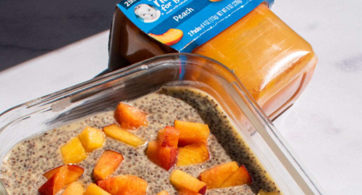 Glass container filled with peach chia pudding made with a container of Gerber peach puree.