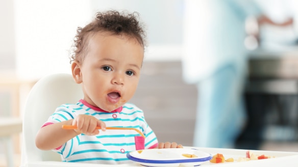 Baby eating by himself