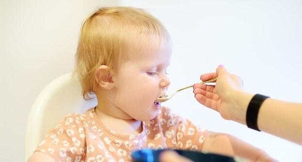 baby eating cereal